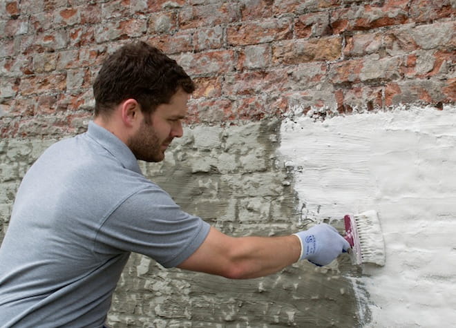 applying tanking slurry in basement