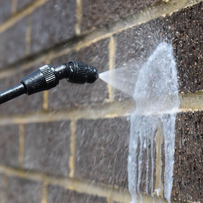 Brick sealer being applied with a sprayer