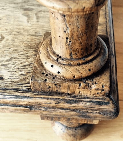 evidence of woodworm in antique furniture